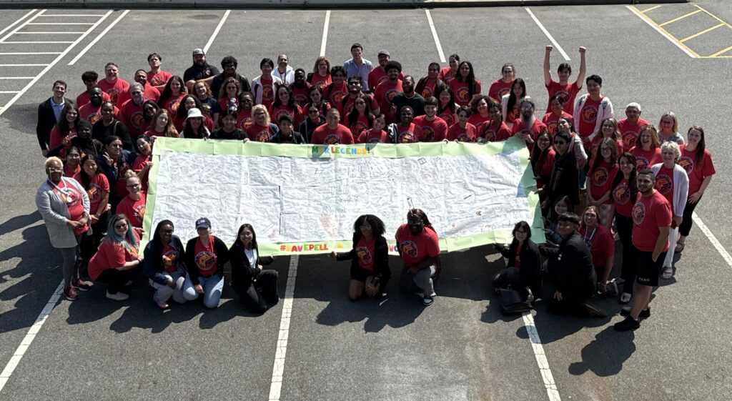 Phi Theta Kappa members take a stand for education equity with a banner declaring why the Pell Grant must be protected.